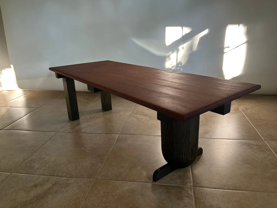 Mahogany coffee table with a polished slab top and dark legs