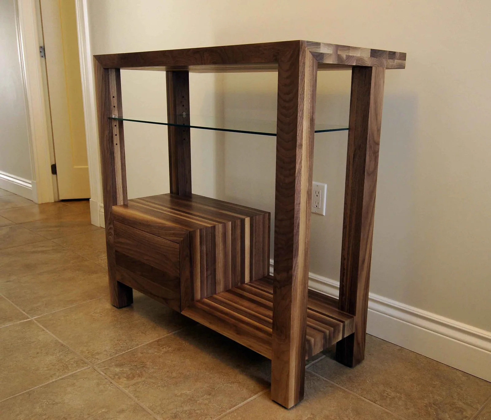 Walnut table with open shelves and a glass top