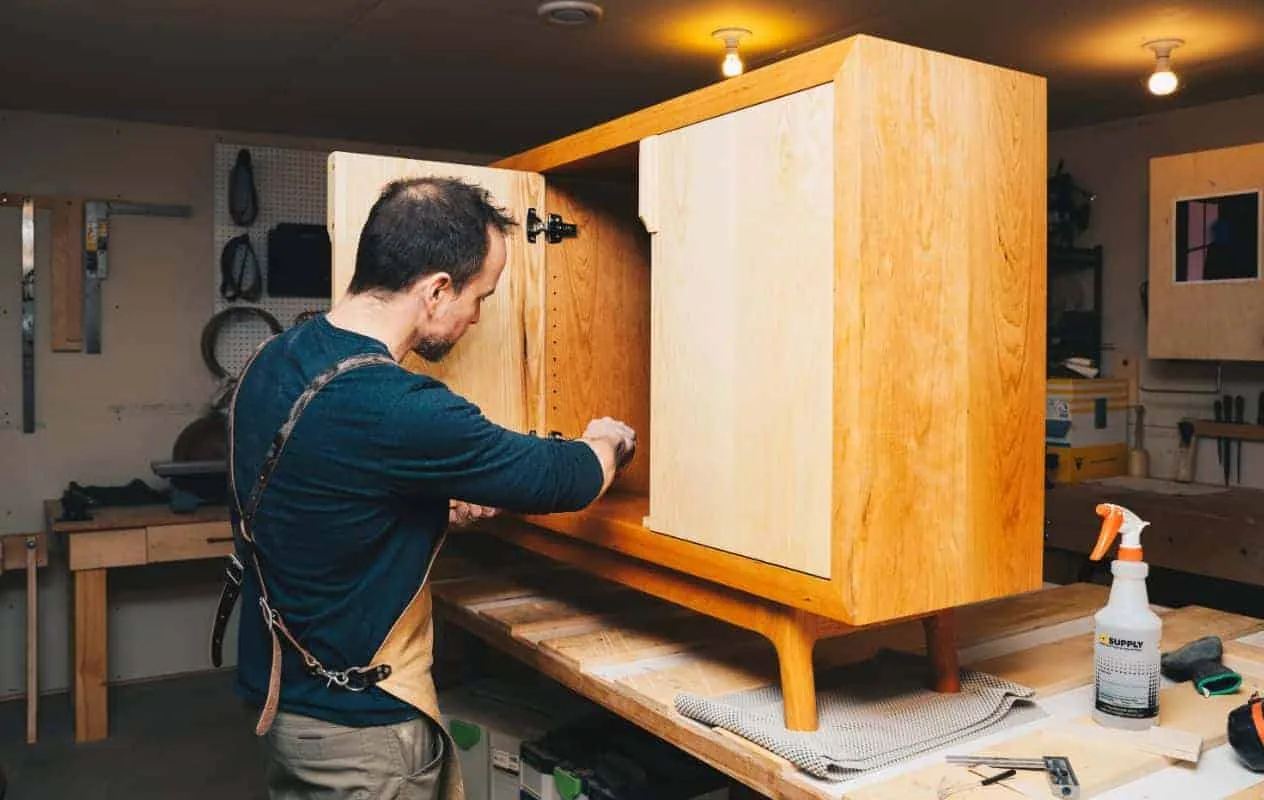 Michael McQuaid fitting the doors on a cherry cabinet on his workbench