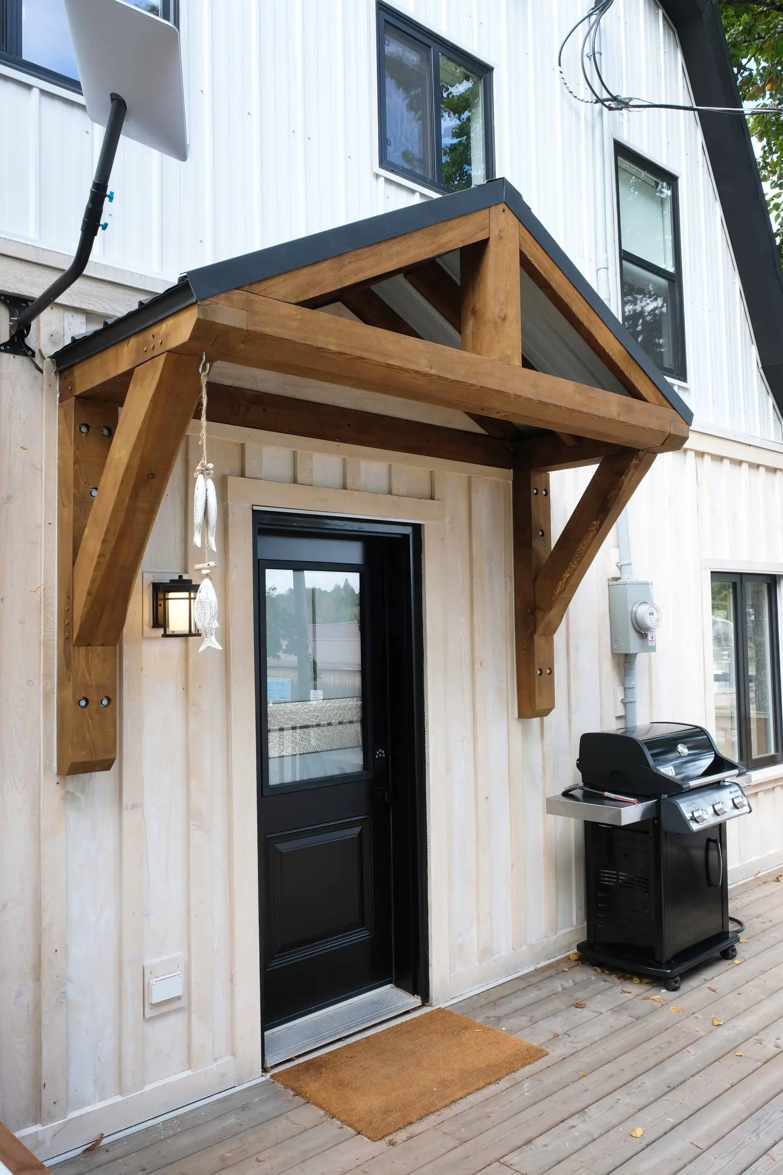 Timber frame entry roof over a front door