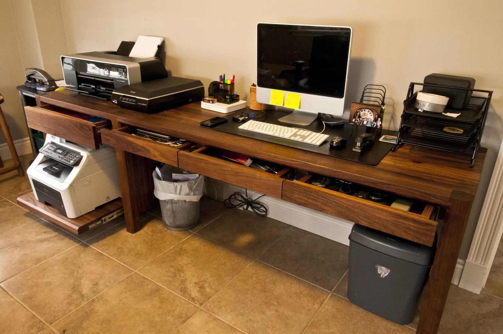 Long walnut office desk with drawers in a home office